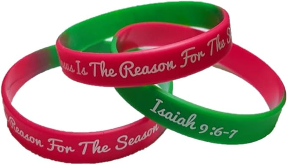 A collection of silicone wristbands in red and green, with the message 'Jesus is the reason for the season' and the Bible verse Isaiah 9:6-7 printed on them.