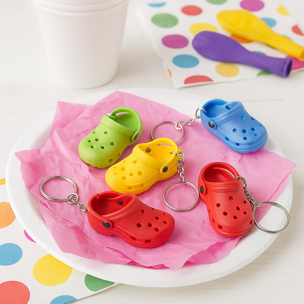 Colorful croc-shaped keychains on a white plate with a polka dot background