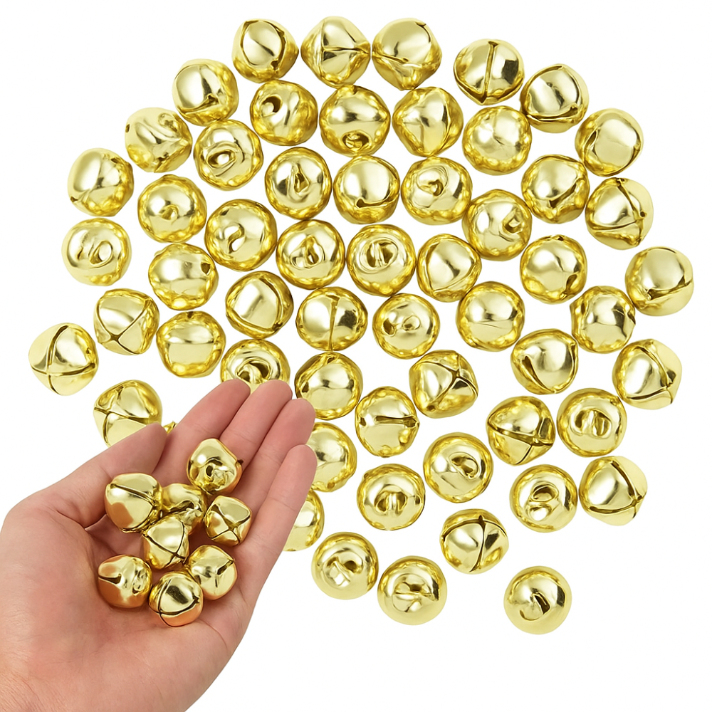 Gold jingle bells on a white background with a hand holding some of them.