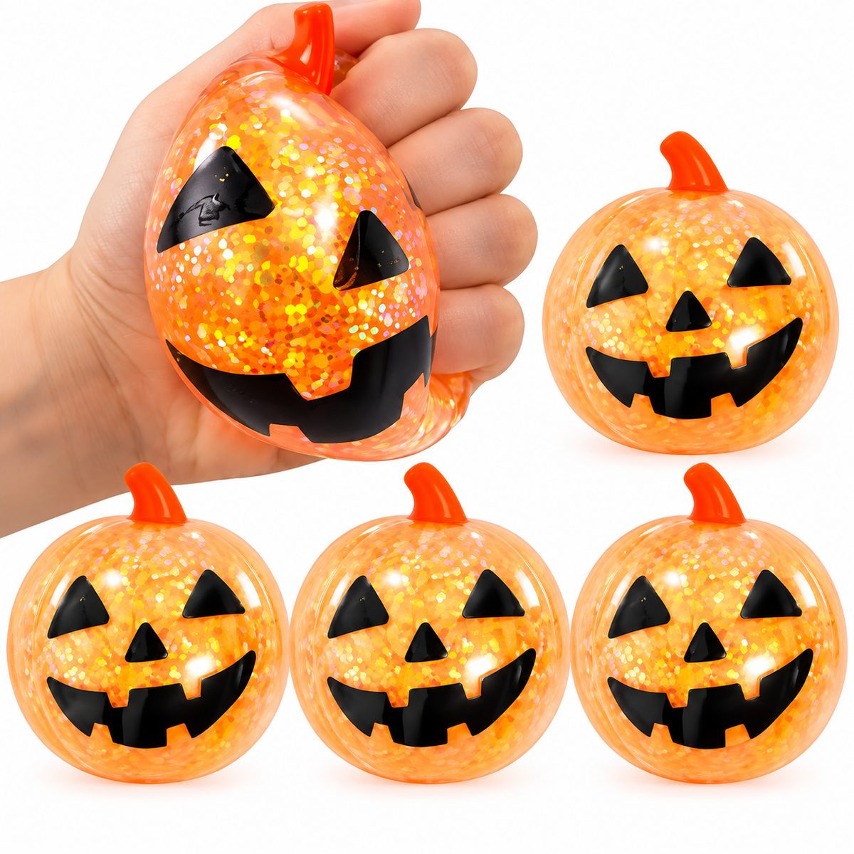 Set of glitter-filled pumpkin squishy toys with jack-o-lantern faces on a white background