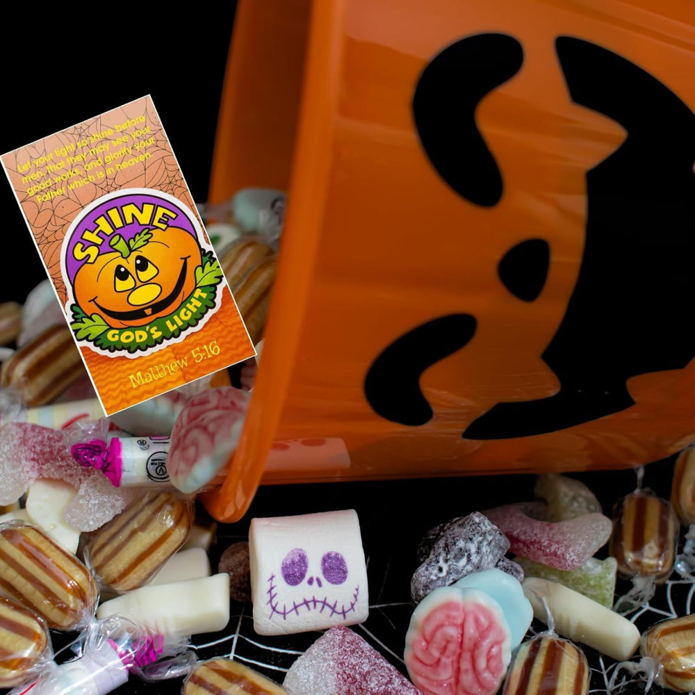 Halloween-themed candy bag with assorted candies and a 'Shine God's Light' box.