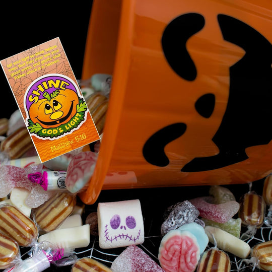 Halloween-themed candy bag with assorted candies and a 'Shine God's Light' box.