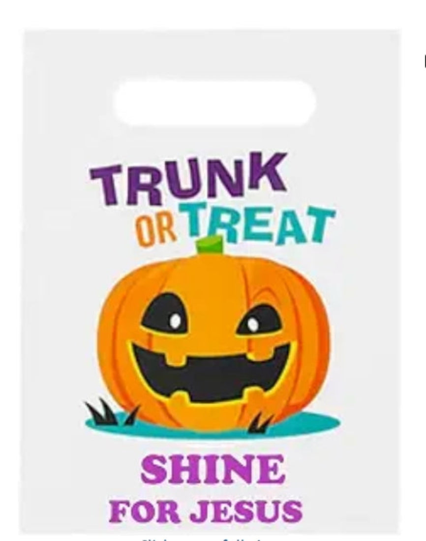 A white plastic Halloween treat bag with a die-cut handle, featuring a cartoon jack-o'-lantern and the text 'TRUNK OR TREAT' and 'SHINE FOR JESUS' in colorful lettering.