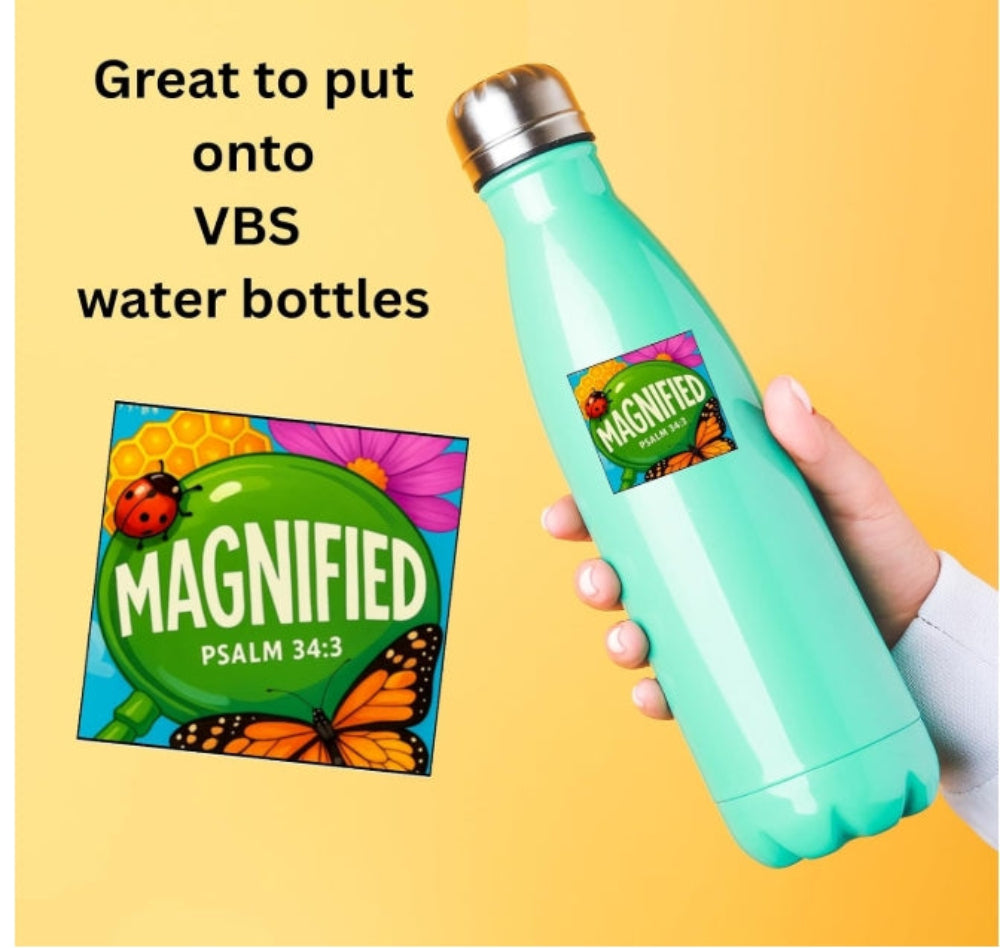 A mint green insulated water bottle with a silver cap is held by a hand against a yellow background. The bottle has a colorful 'MAGNIFIED' label.