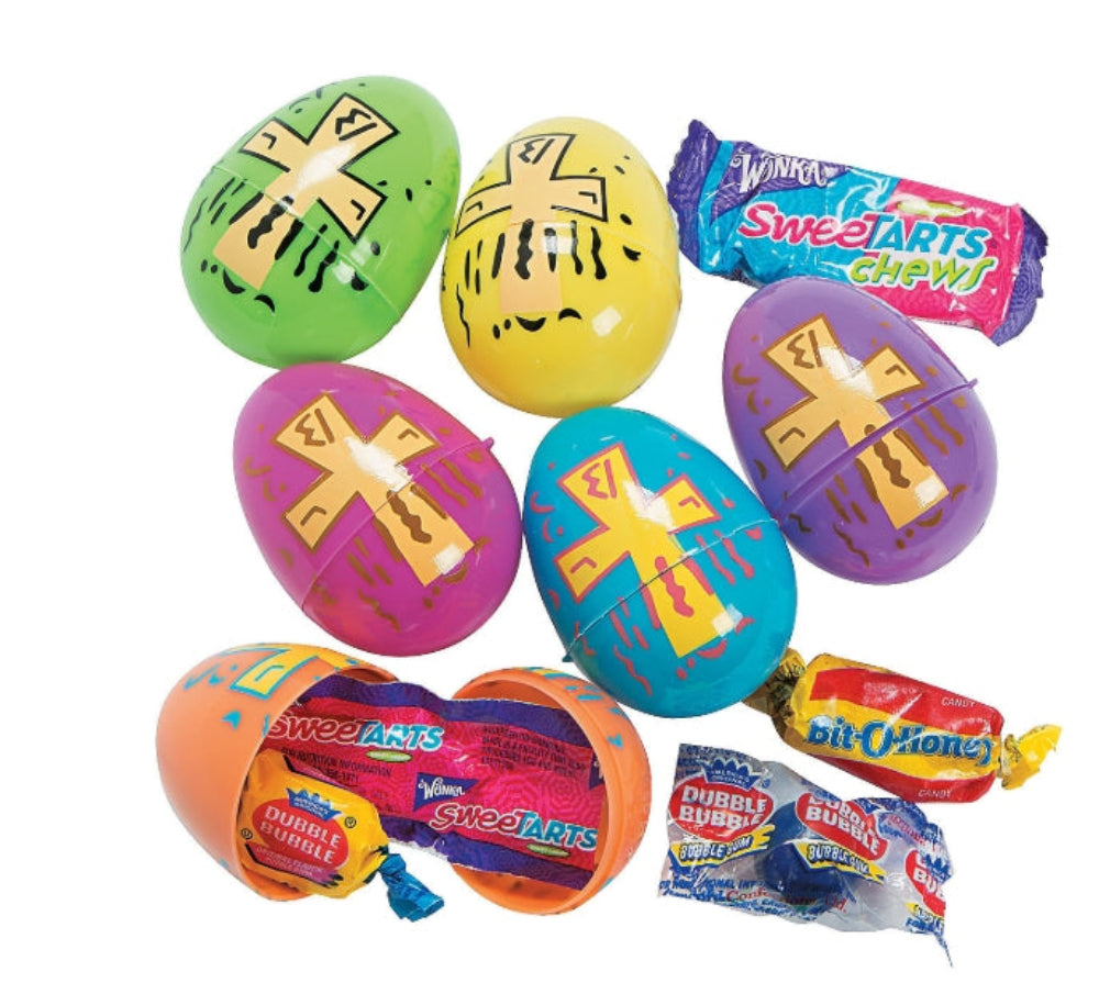 Assorted colorful plastic Easter eggs with Christian cross prints, some filled with individually wrapped candy, displayed against a white background.