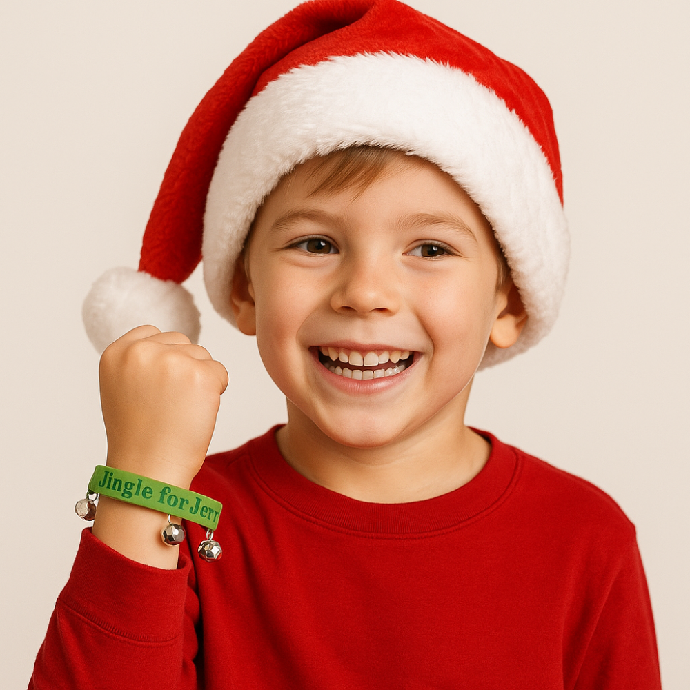 boy wearing jingle for Jesus bracelet with Santa hat on