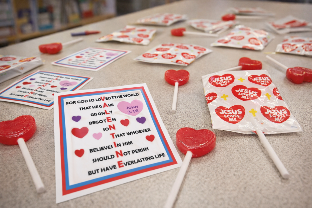 Valentine's Day-themed lollipops and cards on a table