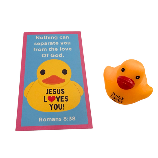 Yellow rubber duck with 'Jesus Loves You' text on a blue card with pink border, on a white background.