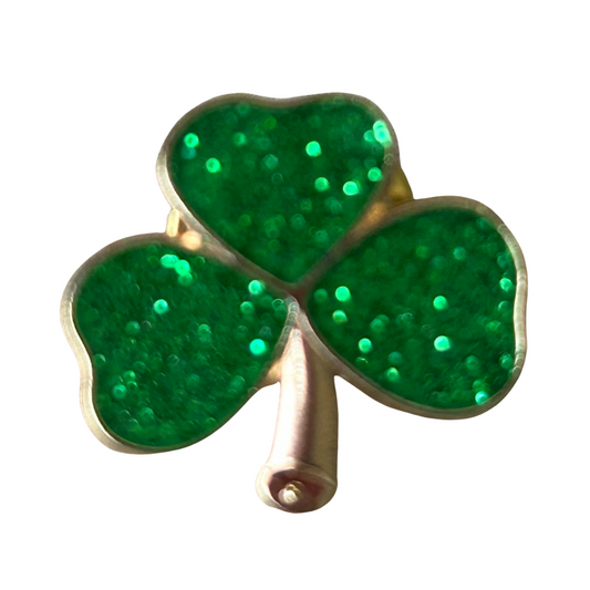 Three-leaf clover brooch with green glittery leaves on a white background