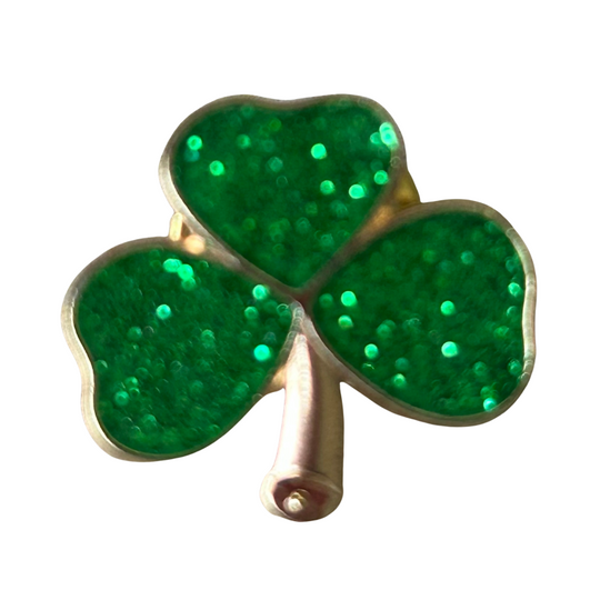 Three-leaf clover brooch with green glittery leaves on a white background