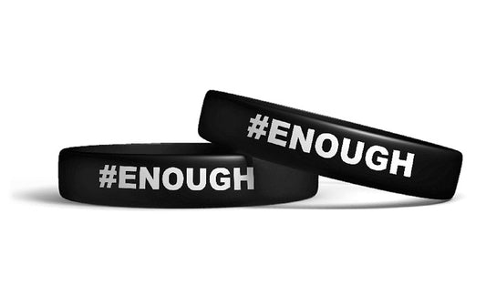 Two black silicone wristbands with the text '#ENOUGH' printed in white.