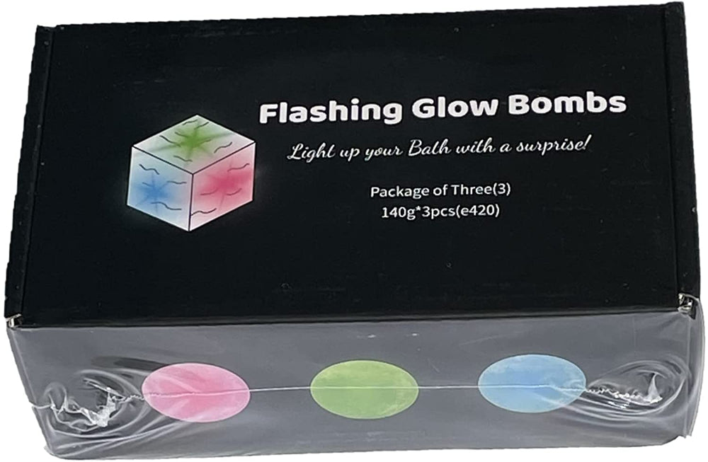 Packaging of three glow in the dark flashing bath bombs in pink, green, and blue colors displayed in front of a black background with the product name 'Flashing Glow Bombs'.