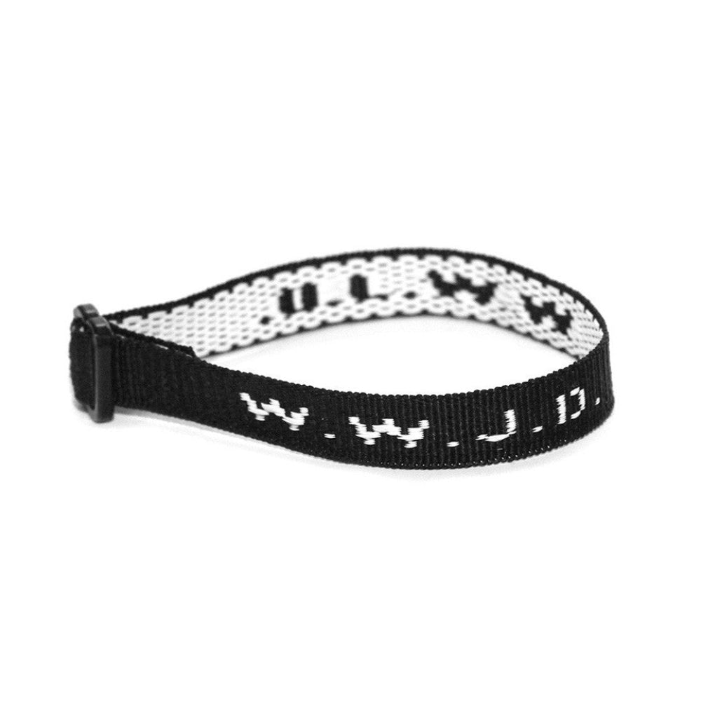A black woven wristband with the text 'W W J D' in white letters, representing the phrase 'What Would Jesus Do?'